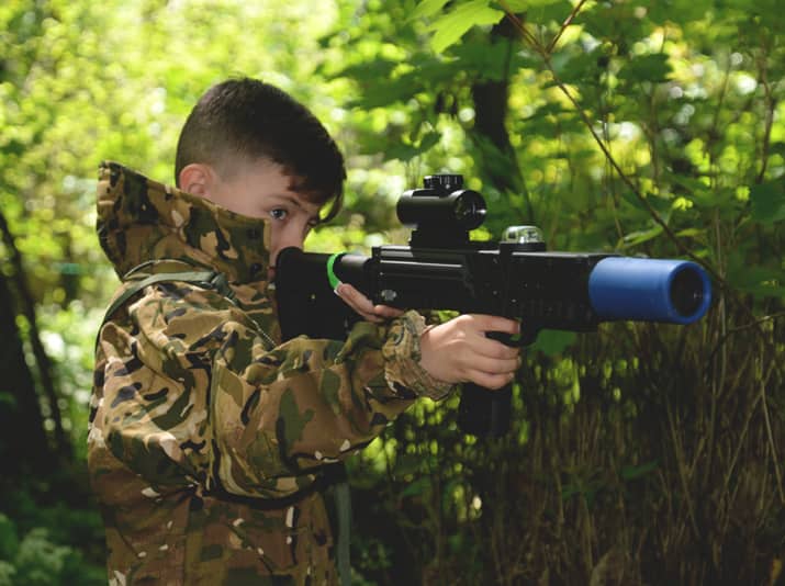 aiming a laser tag london weapon in the forest